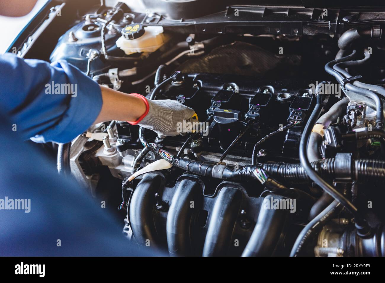 Car mechanic holding checking gear oil to maintenance vehicle by