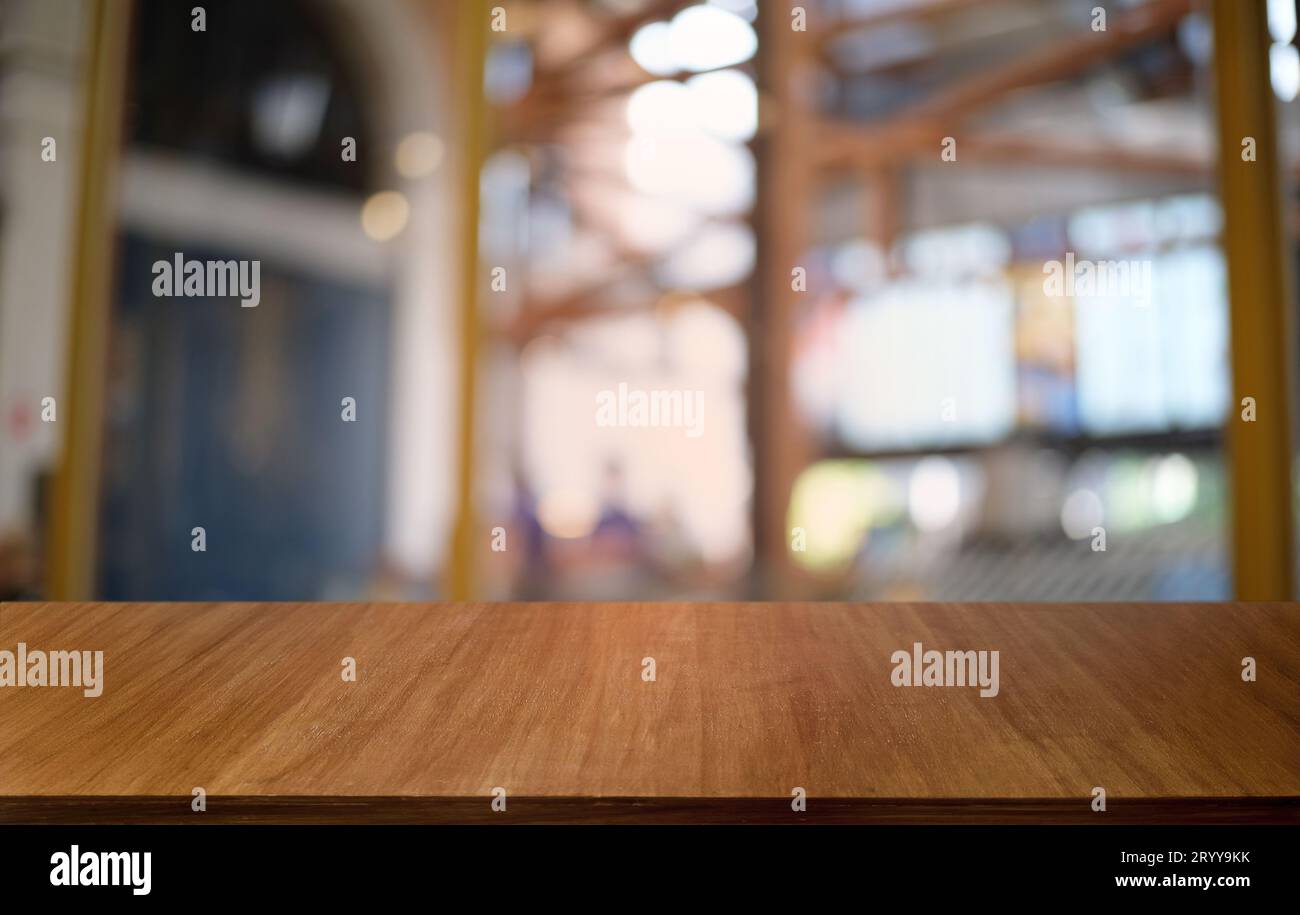 Empty dark wooden table in front of abstract blurred bokeh background of restaurant . can be used for display or montage your pr Stock Photo