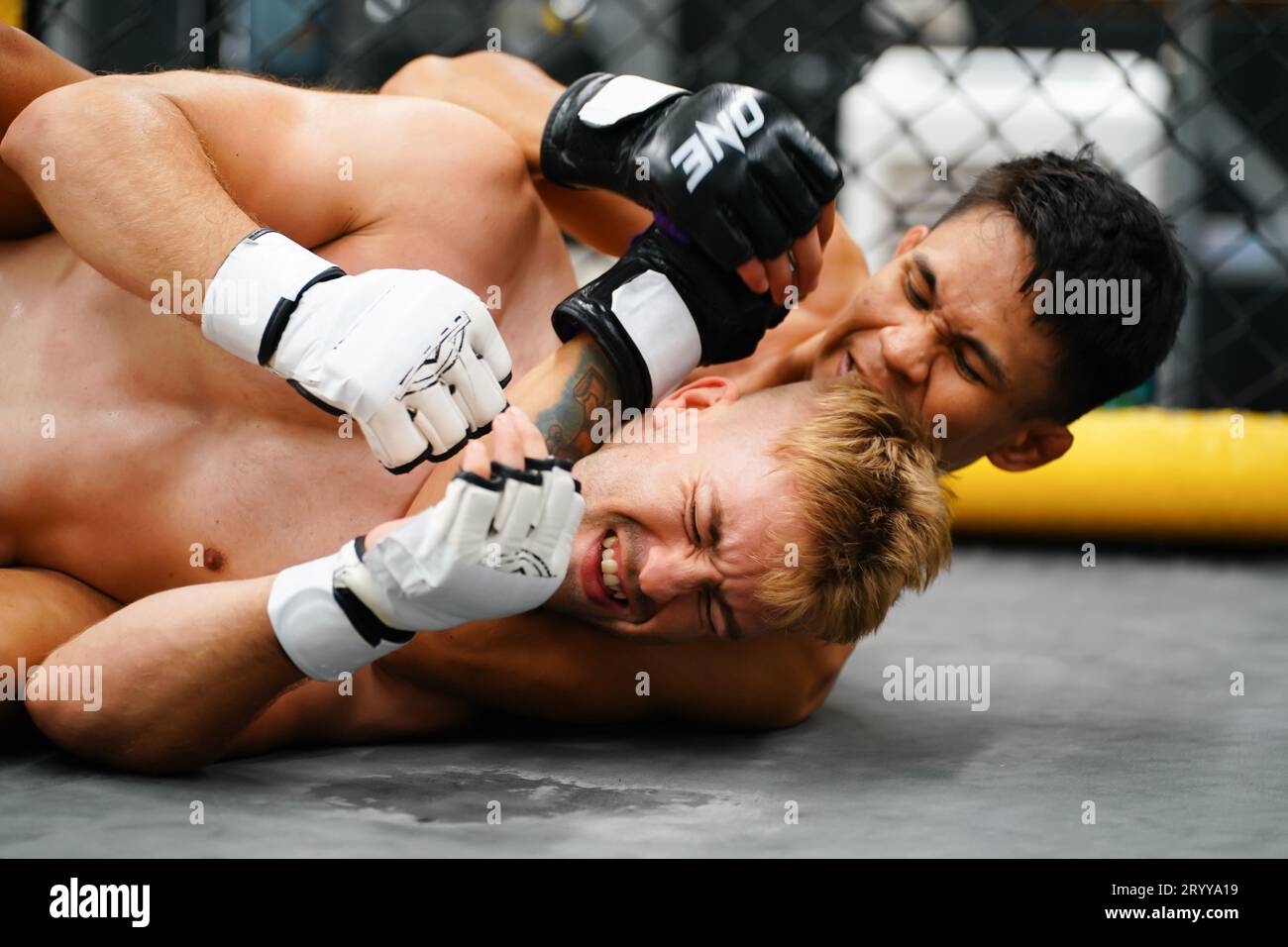 Mixed Martial Art, When the opponent is knocked down then use your hands to strangle your opponent's neck. making it difficult f Stock Photo