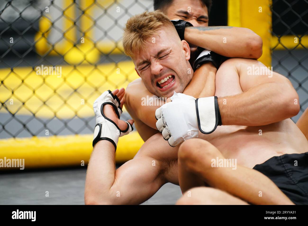 Mixed Martial Art, When the opponent is knocked down then use your hands to strangle your opponent's neck. making it difficult f Stock Photo