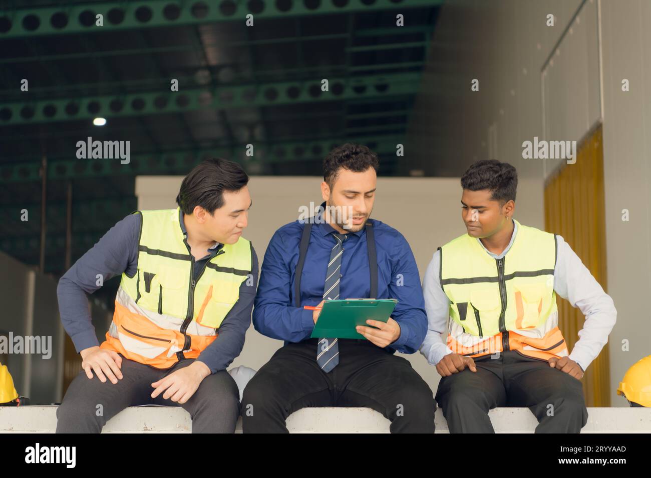 A warehouse manager and two employees are resting after dealing with ...