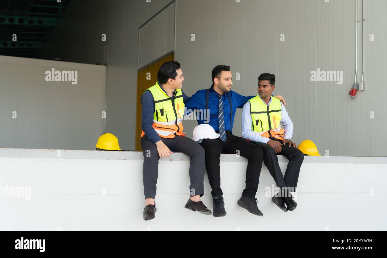 A warehouse manager and two employees are resting after dealing with ...