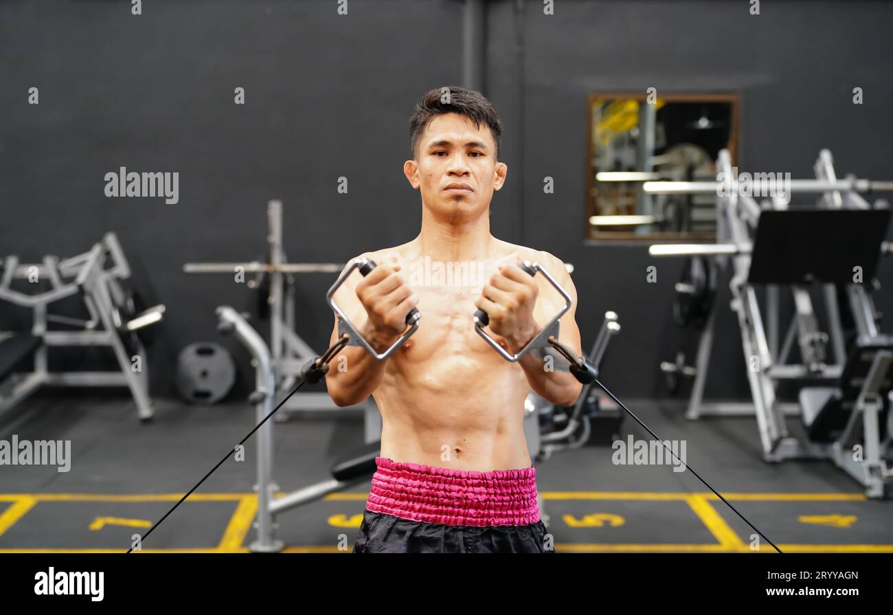 Mixed martial arts fighter going to the gym to build strong muscles To