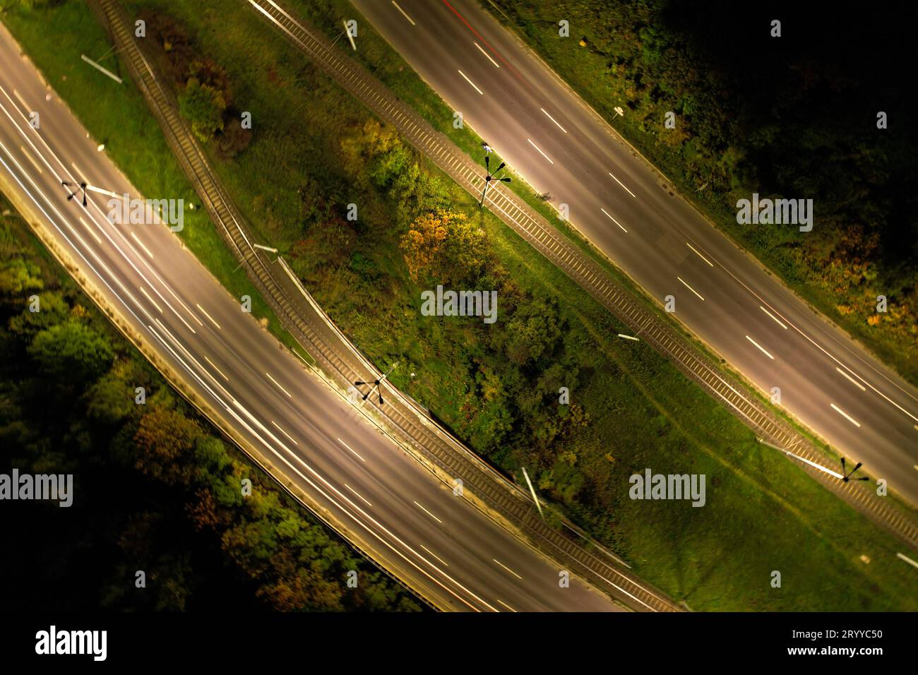 Top down view to road. Romantic night aerial photo of cars traveling. The light on the road at night in city. Background scenic Stock Photo