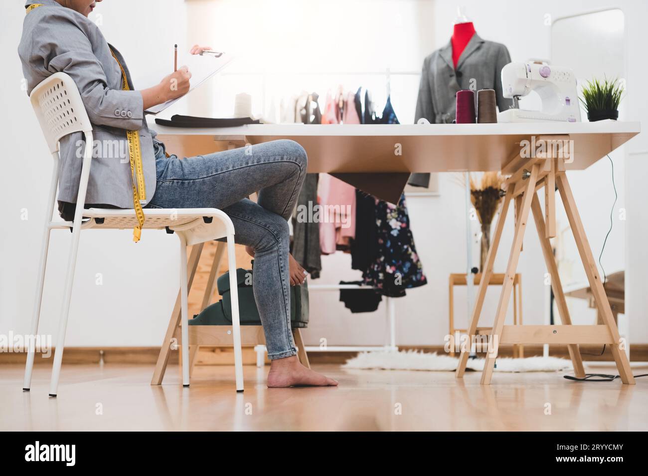 Attractive Asian female fashion designer working in home office