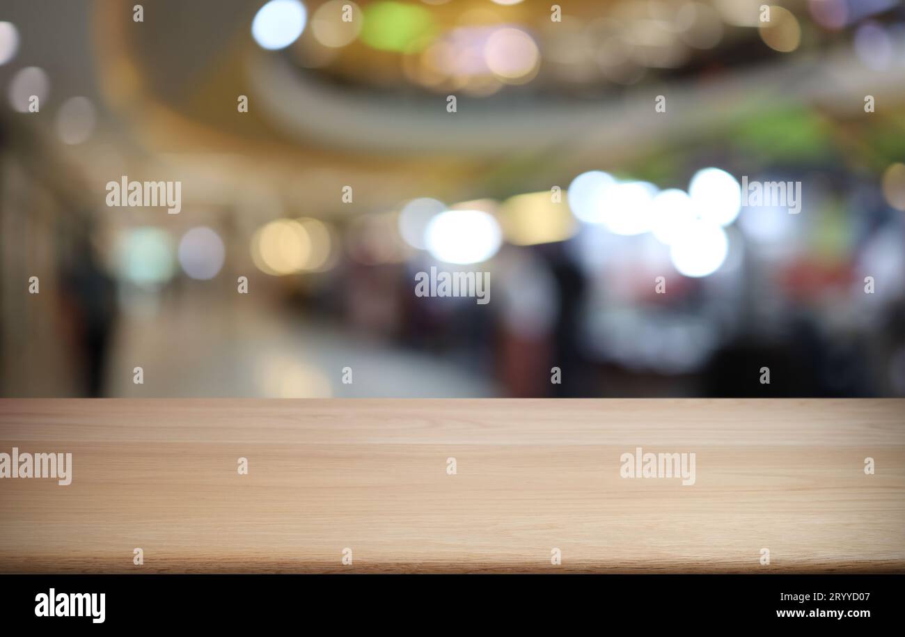 Empty wooden table in front of abstract blurred background of coffee shop . can be used for display or montage your products.Moc Stock Photo
