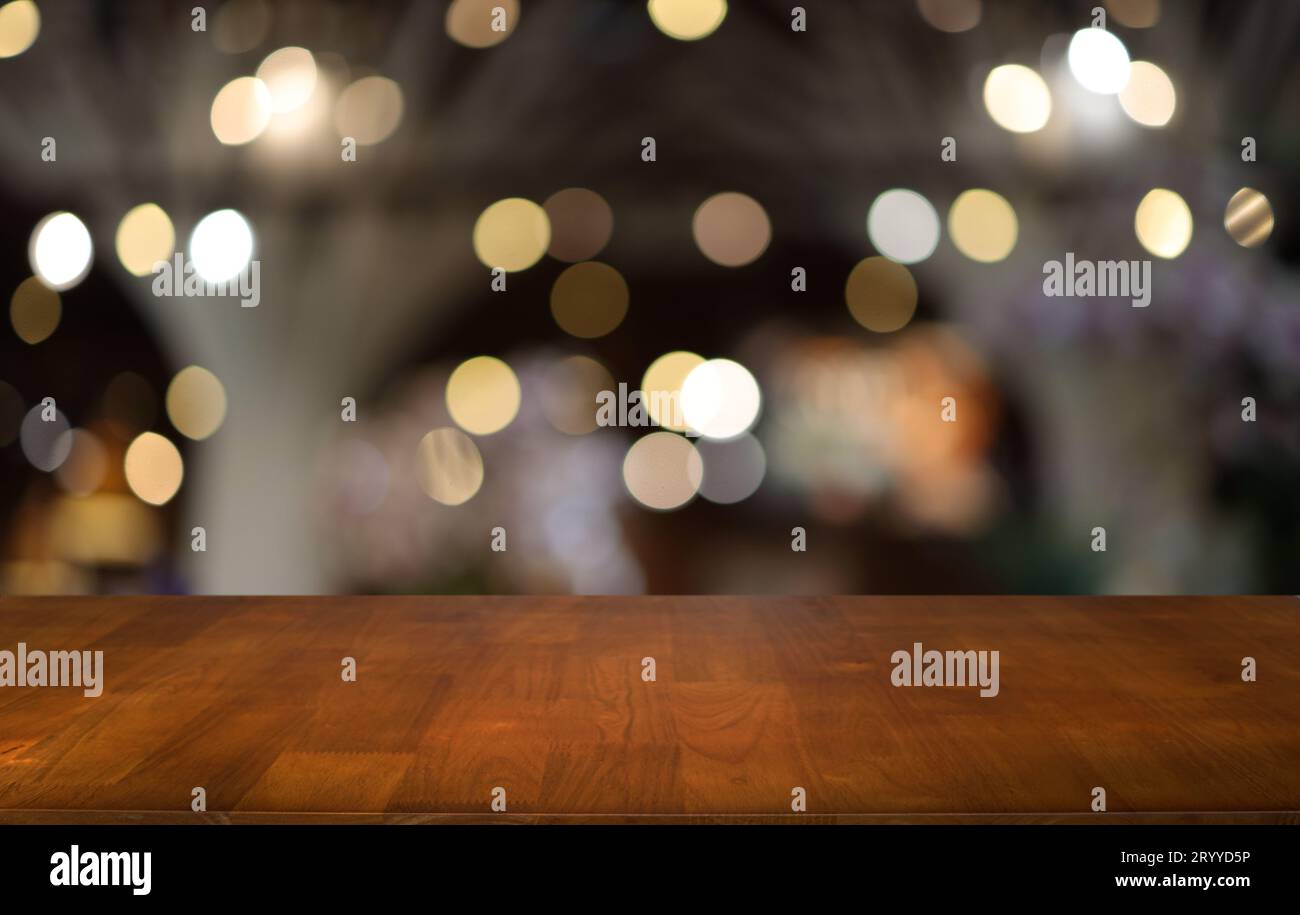 Empty wooden table in front of abstract blurred background of coffee shop . can be used for display or montage your products.Moc Stock Photo