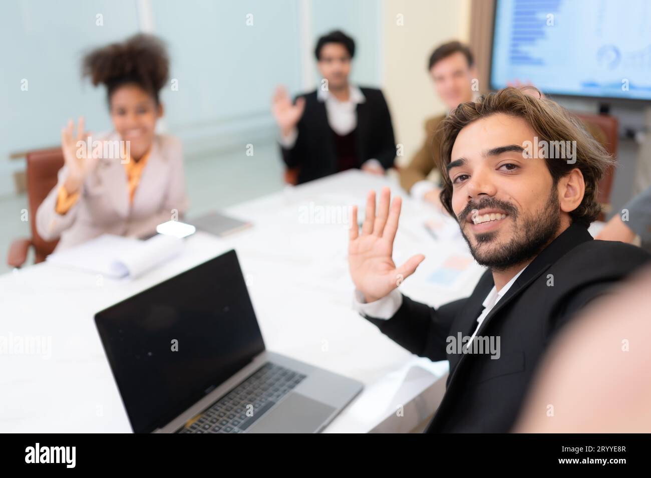 A diverse group of young business people taking selfies In the conference room of an international business company while waitin Stock Photo