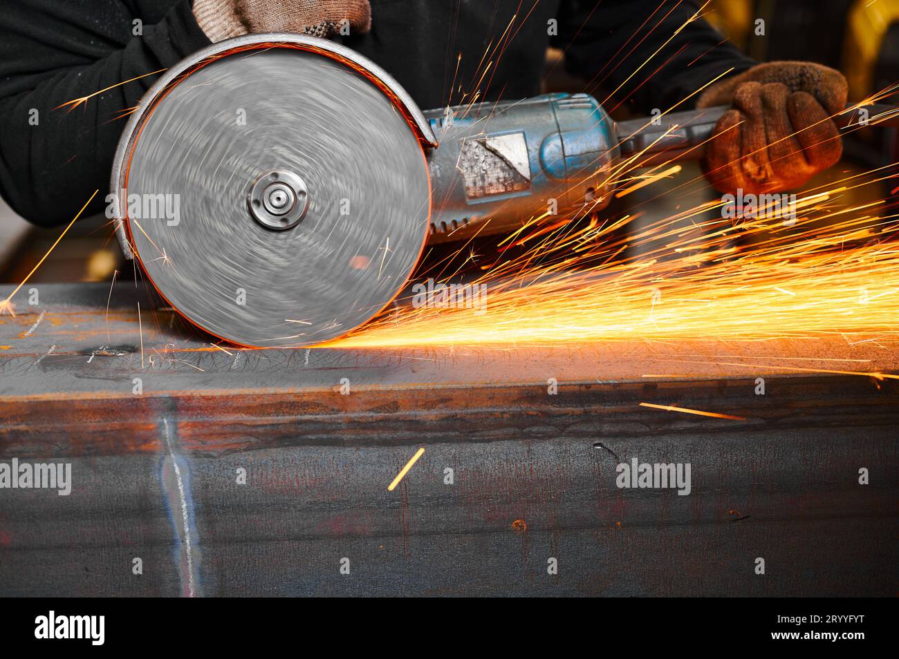 Cutting of metal beam with abrasive tool at metalwork plant Stock Photo