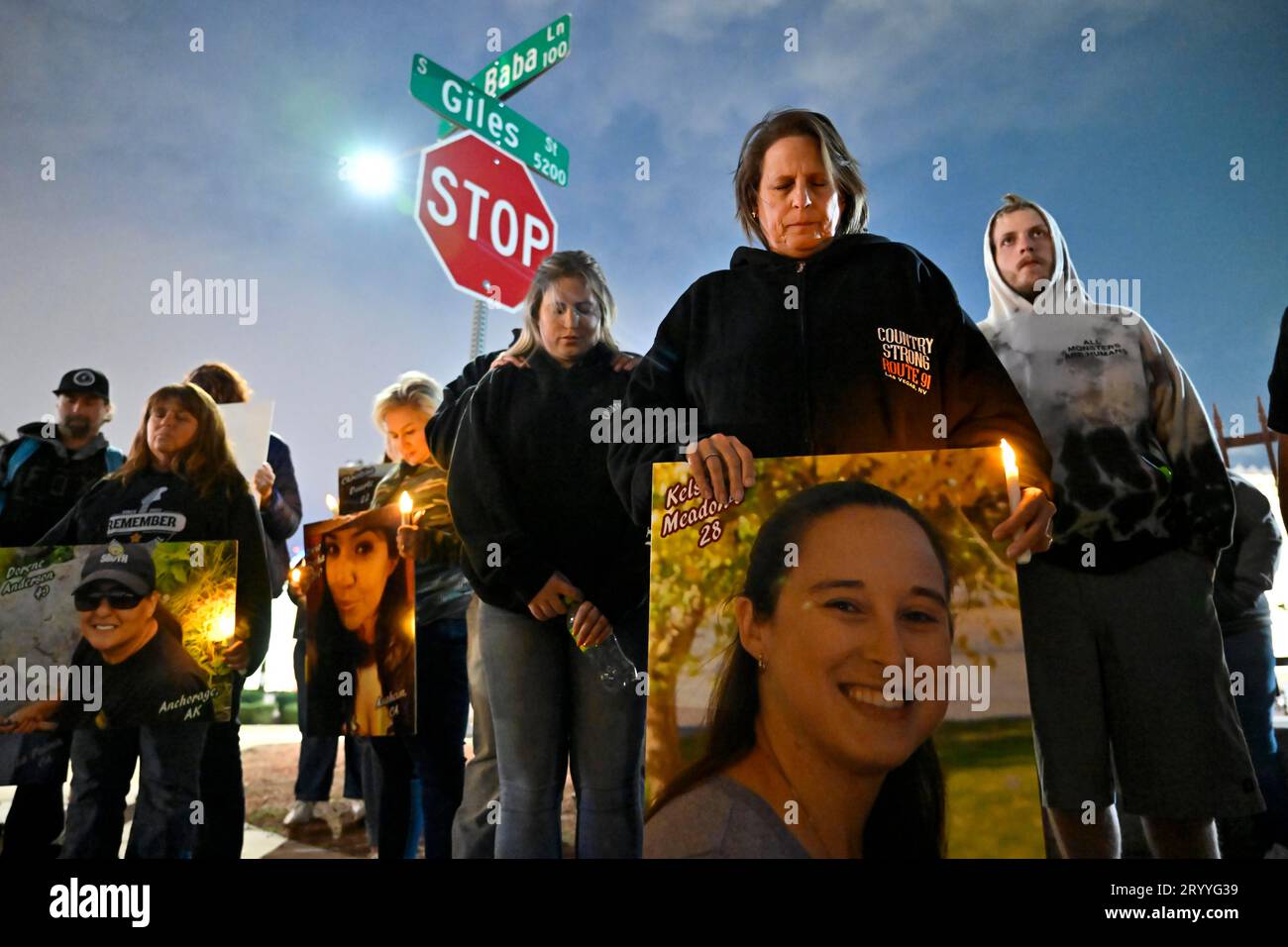 Las Vegas, Nevada, USA. 1st Oct, 2023. A moment of silence is had while people display photographs of victims from the 2017 Las Vegas mass shooting near the venue on October 1, 2023, in Las Vegas, Nevada. Approximately 150 people braved the unexpected rain and cold wind at the former Las Vegas Village to honor and remember the 58 people who were killed six years ago by a lone gunman during the Route 91 Harvest Music Festival from the 32nd story of Mandalay Bay Resort and Casino on October 1, 2017. Fifty-eight people died initially with two additional people dying later due to their injuries, Stock Photo