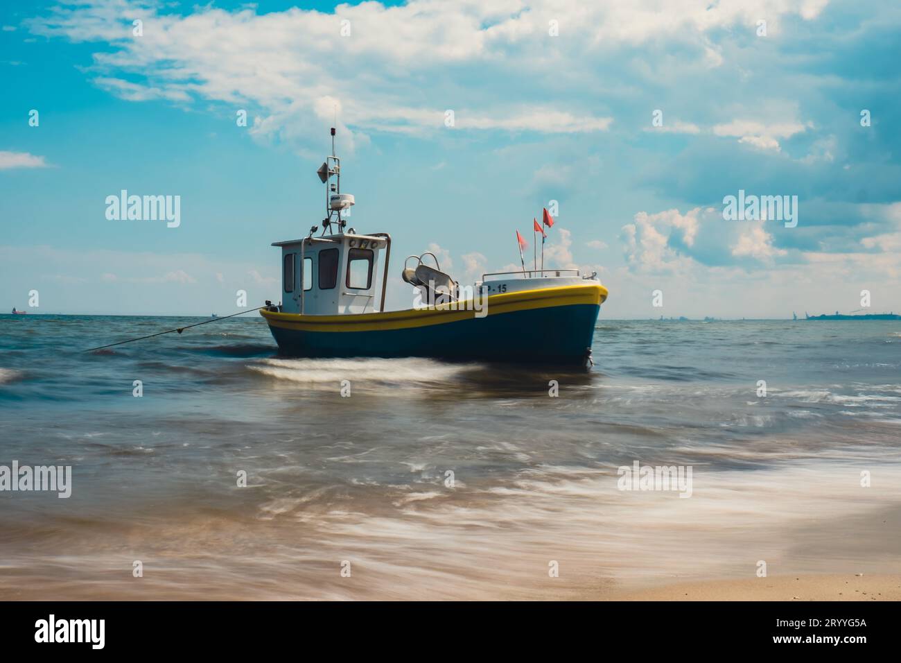 Fishing boat on the beach in Sopot, Poland. Magnificent long exposure calm Baltic Sea. Wallpaper defocused waves. Fishermans sea Stock Photo