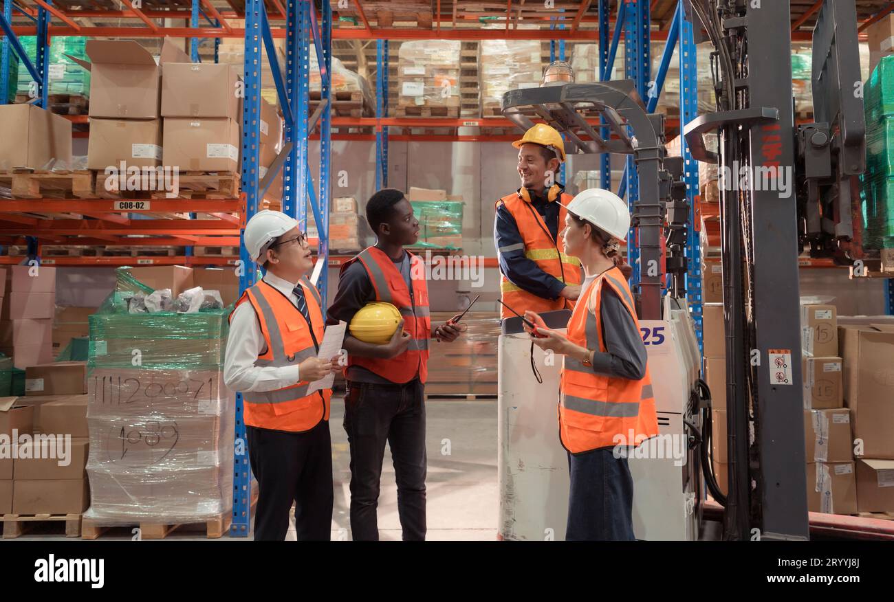 Managers, foremen and warehouse workers Consult together about getting the goods out of the warehouse to finish sending the smal Stock Photo