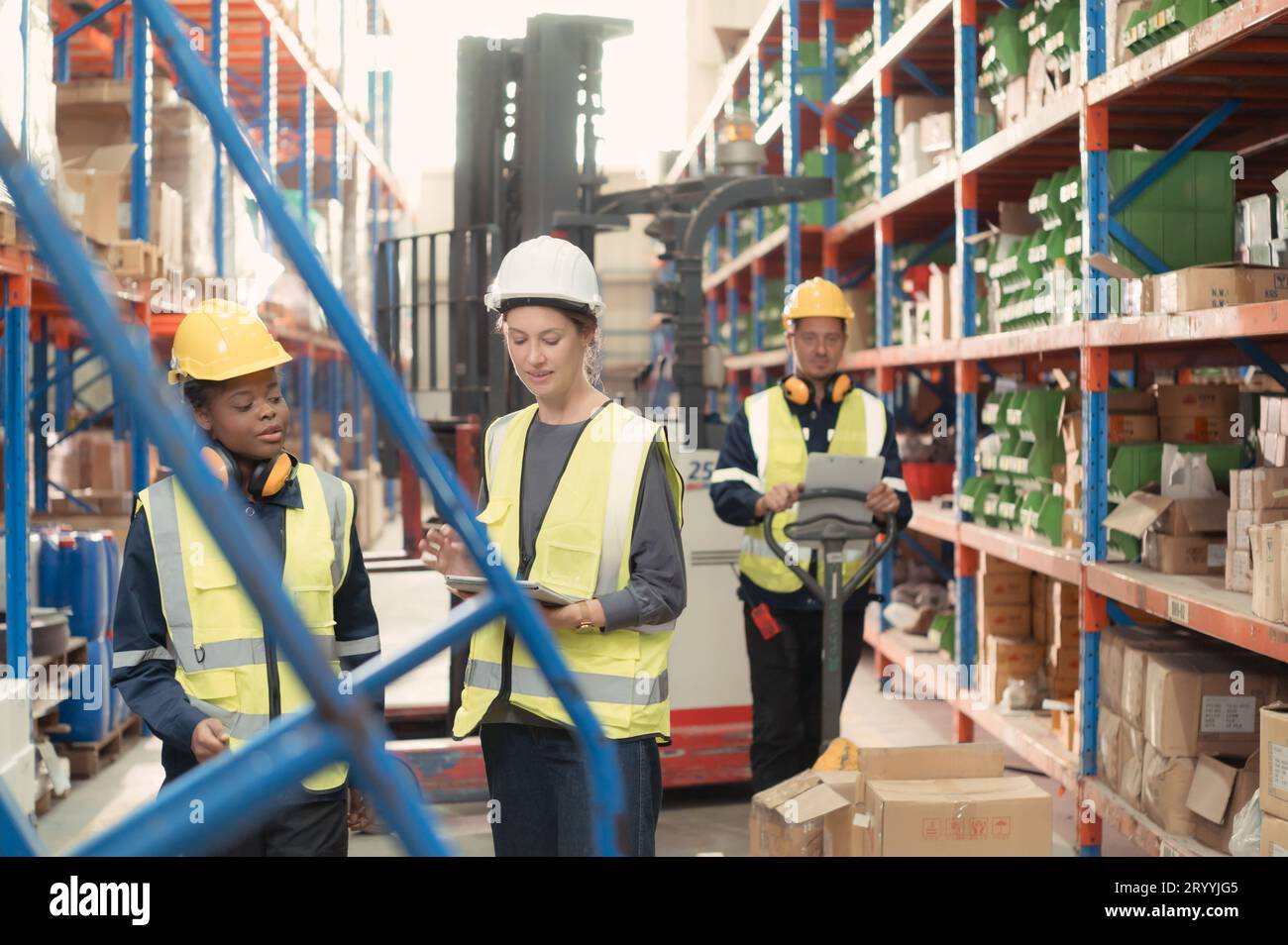 Manager with foreman and warehouse personnel, Manage and monitor inventory preparation for distribution to regional sub-centers. Stock Photo