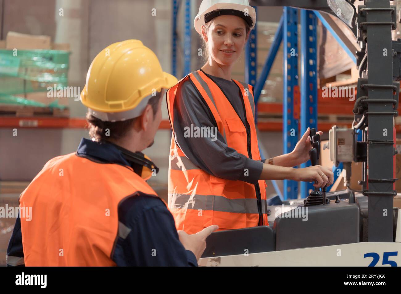 Manager with foreman discuss about the equipment used to move goods in