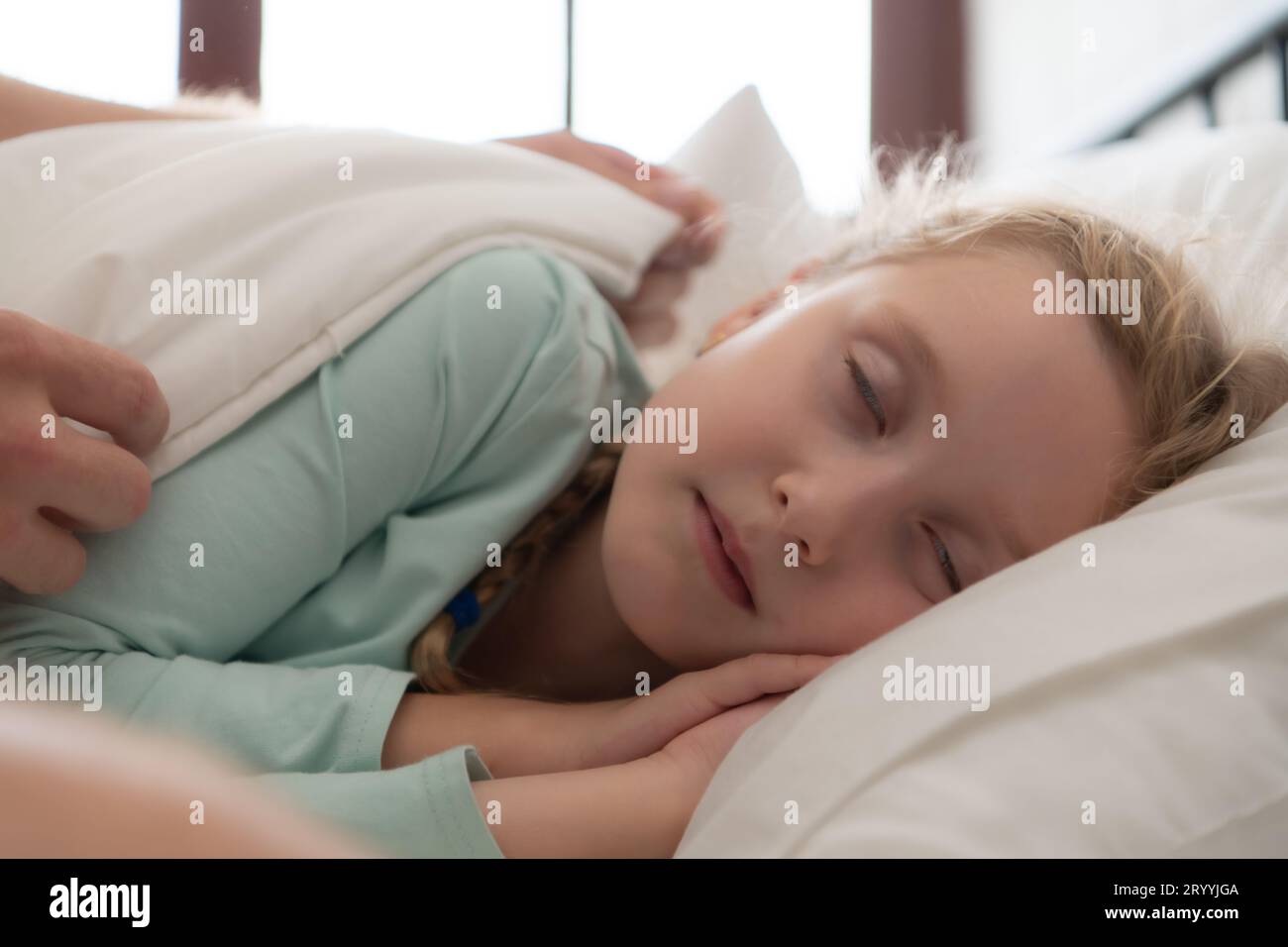 A father enjoys talking with his daughter in his bedroom. before saying goodbye and sending her daughter to bed Stock Photo