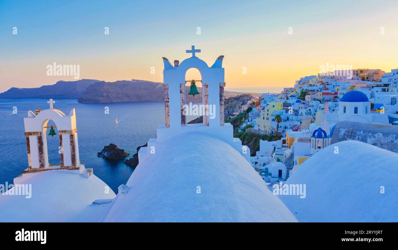 White churches an blue domes by the ocean of Oia Santorini Greece, traditional Greek village Stock Photo