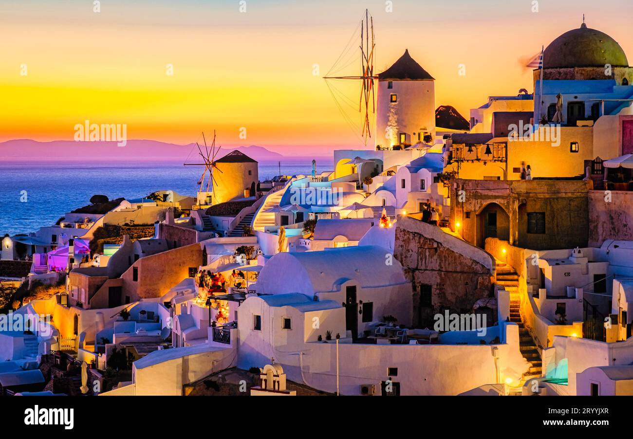 White churches an blue domes by the ocean of Oia Santorini Greece, traditional Greek village Stock Photo