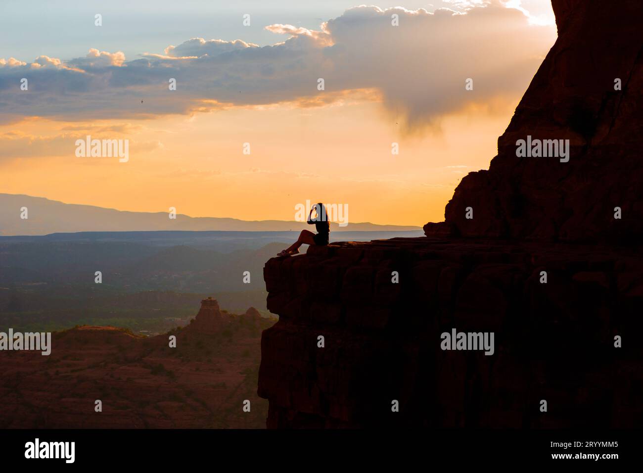 Young hiker woman on the edge of a cliff at Cathedral Rock in Sedona ...