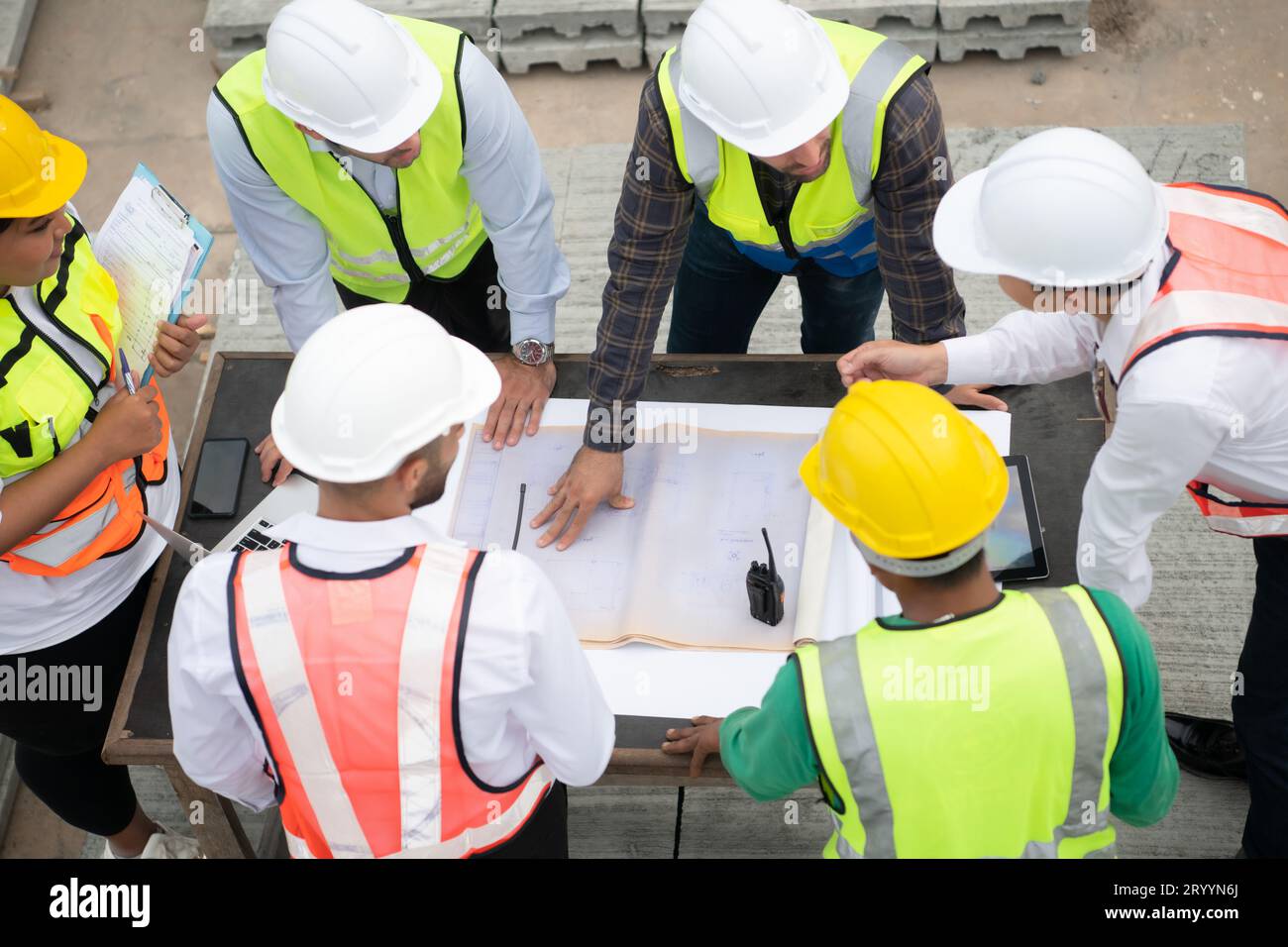 Construction engineers, architects, and foremen form a group. Participate in a meeting to plan new construction projects. Stock Photo