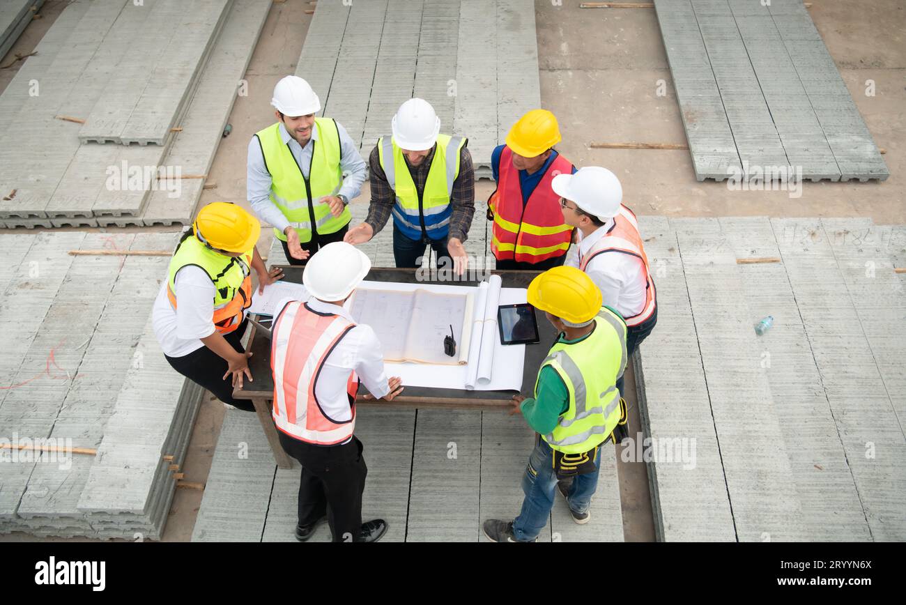 Construction engineers, architects, and foremen form a group. Participate in a meeting to plan new construction projects. Stock Photo