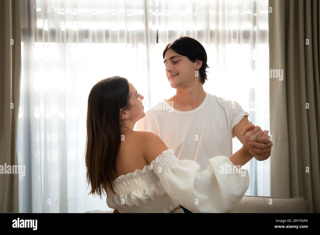 Young couple in the living room of the house in the morning, Dancing happily together Stock Photo
