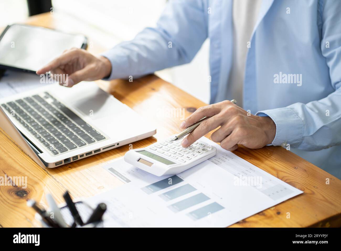 Asian businessman  In the Data Mining Center Statistician with Monitors Displaying business finance technology and investment. S Stock Photo