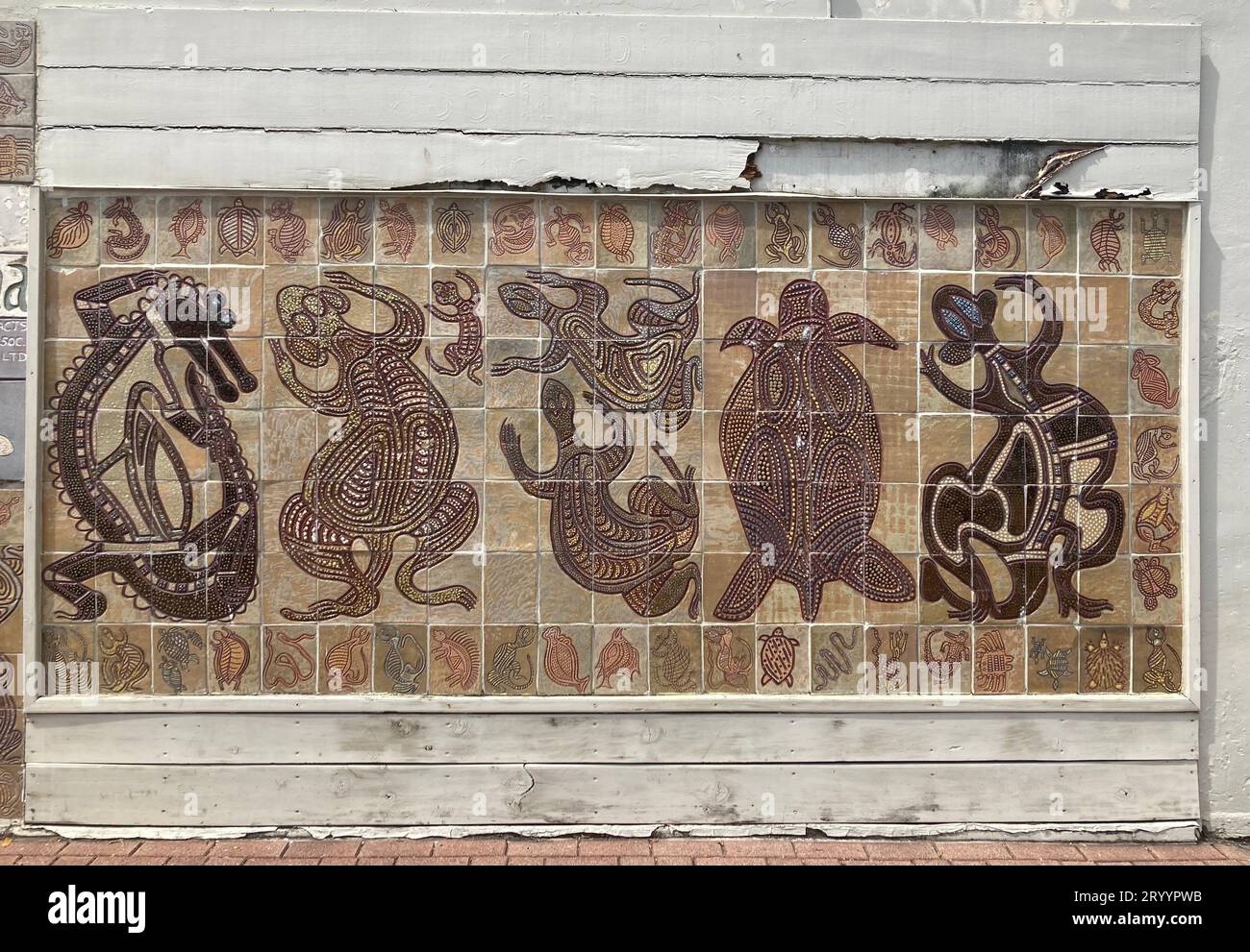 Brown tile wall mosaic with aboriginal art designs on the streets of