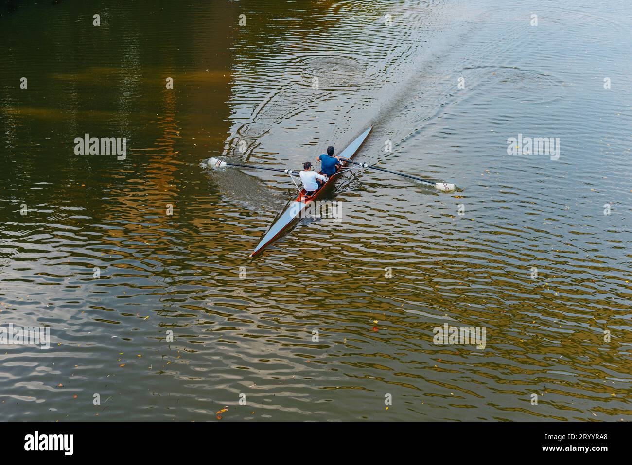 Aerial drone bird's eye view of sport canoe operated by 2 young men in turquoise clear waters. Kayaking on the river. Two young Stock Photo