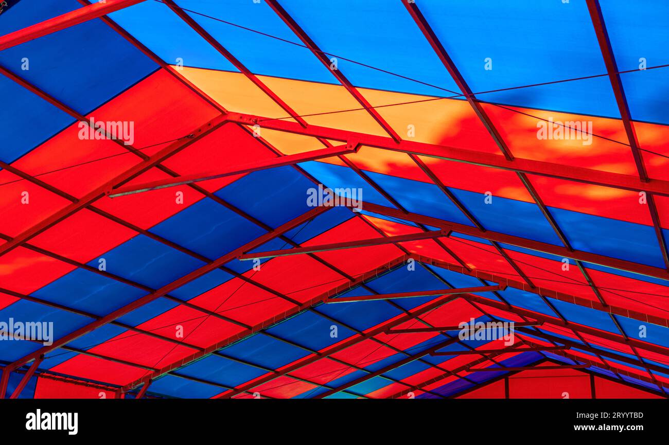 colorful canvas roof of pavilion in city amusement park with structure ...