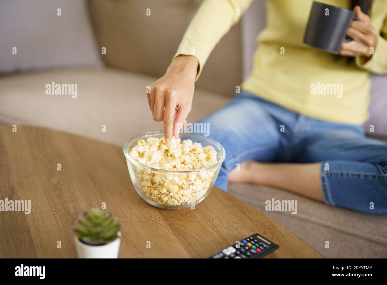 Asian woman Watching smart TV and using remote controller Hand holding ...
