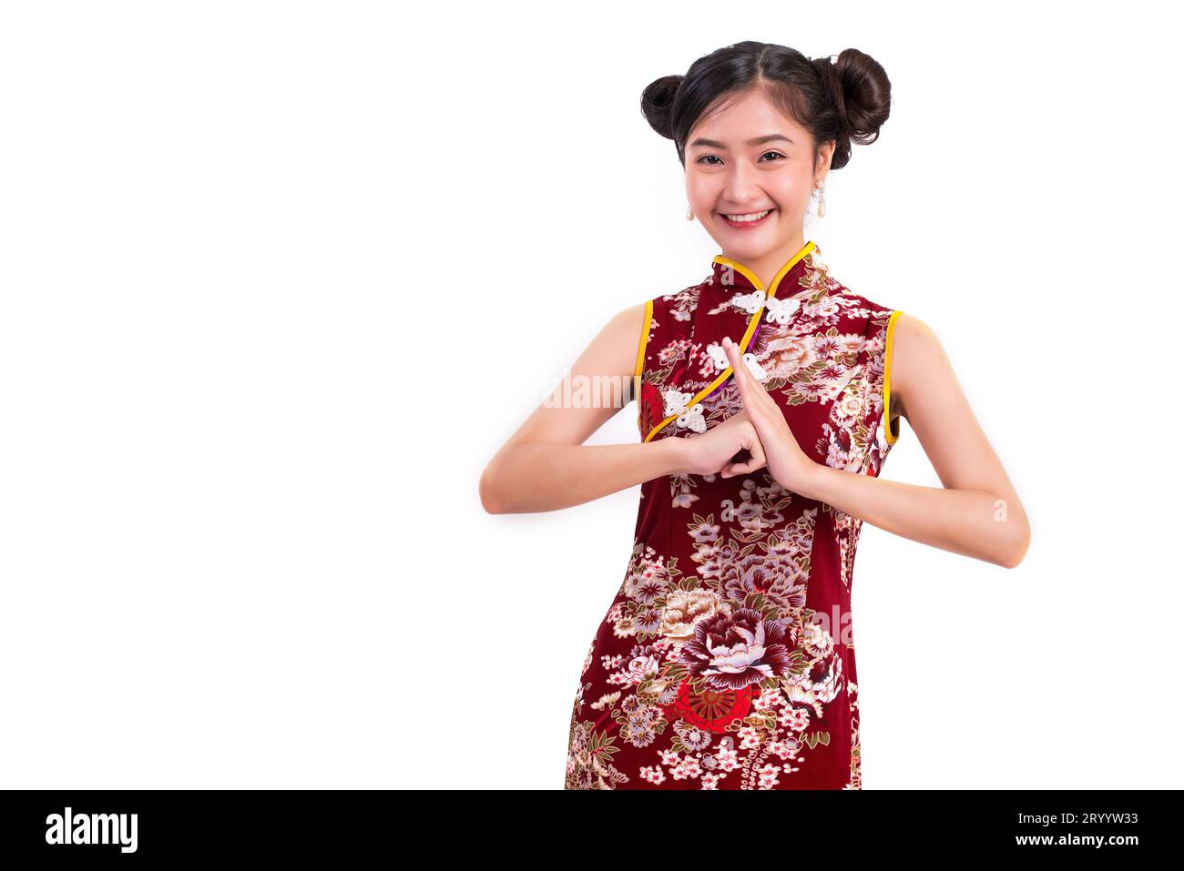 Young Asian beauty woman wearing cheongsam and blessing or greeting gesture in Chinese new year festival event on isolated white Stock Photo