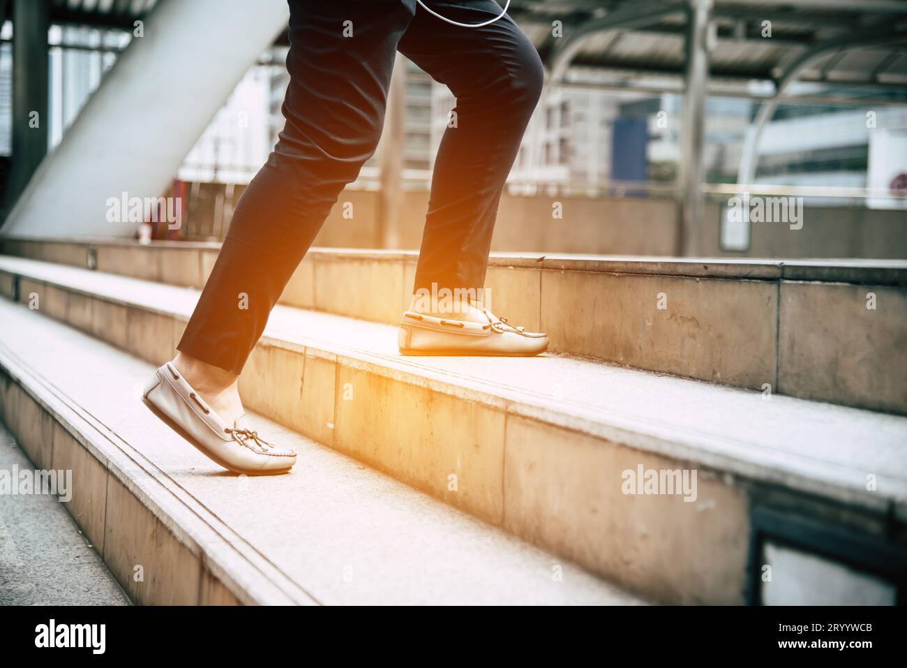 Close up legs of traveling people walking on stepping up stair in
