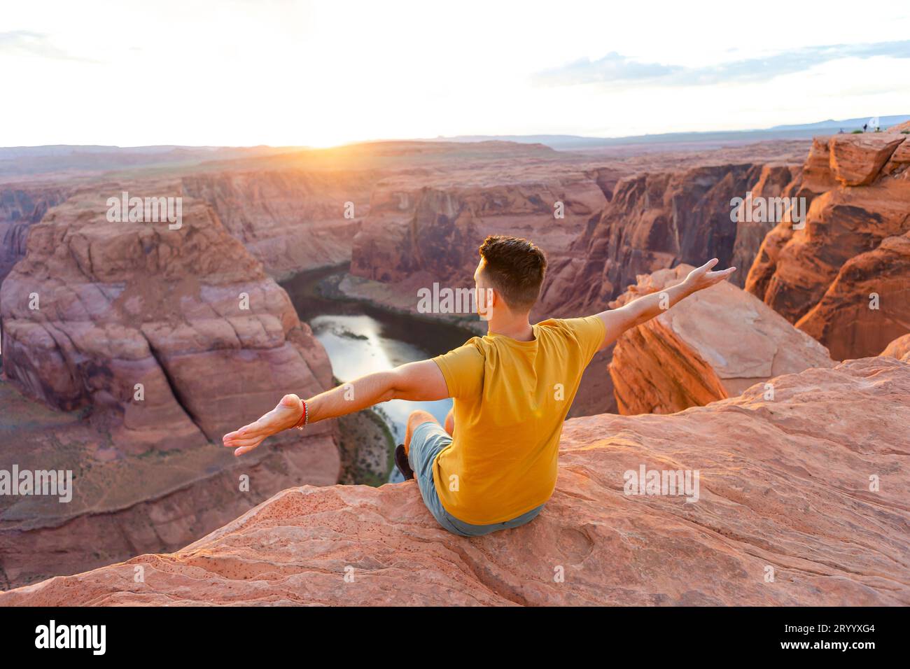 Happy man on the edge of the cliff. Horseshoe Bend Canyon in Page