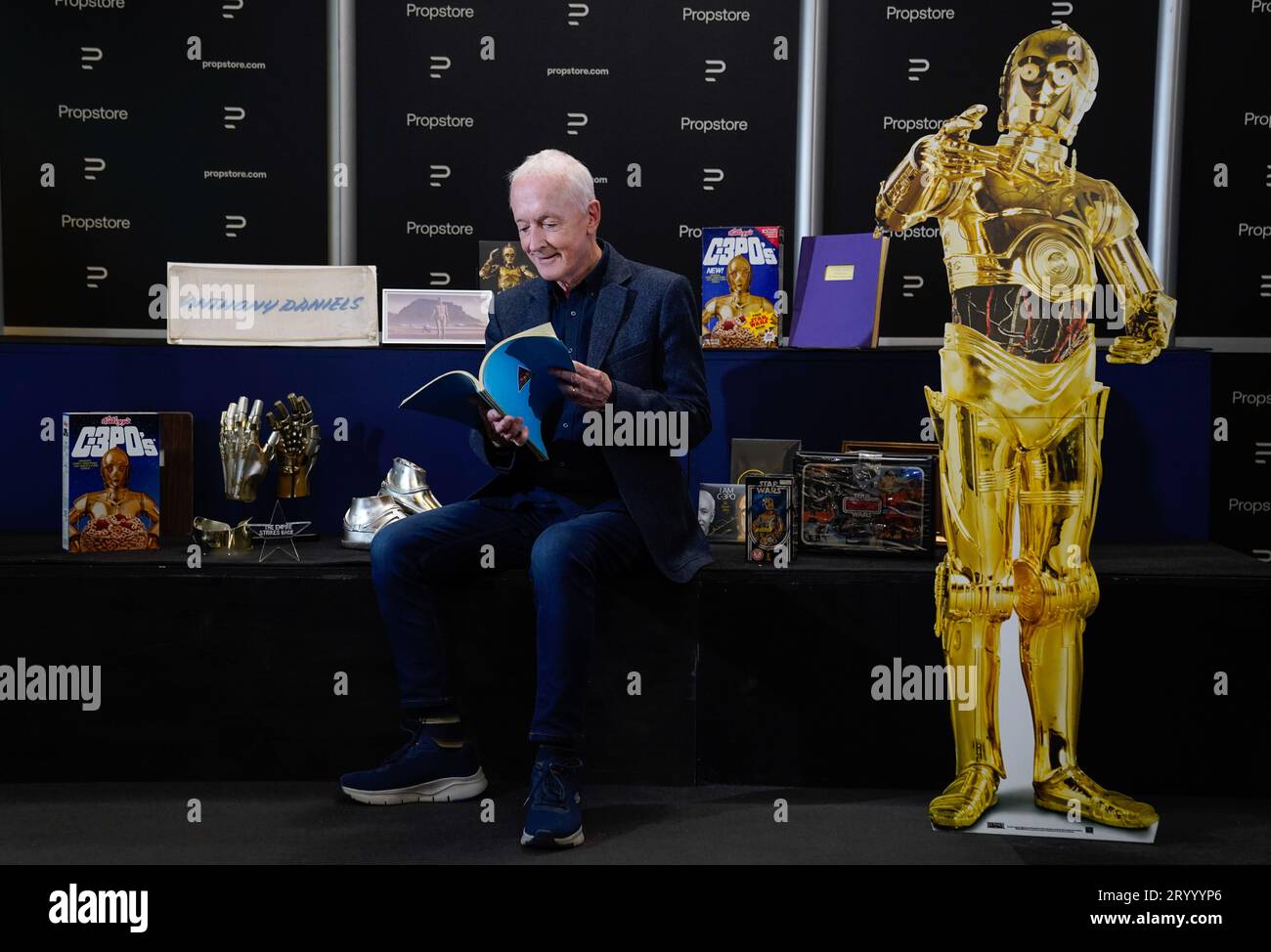 Anthony Daniels reads an original third-draft script from the 1977 film 'Star Wars: A New Hope' (estimated £10,000 - 20,000) as he poses for a photograph alongside other pieces of Star Wars memorabilia from his personal collection, during a preview for the showbiz memorabilia auction, at the Propstore in Rickmansworth, Hertfordshire. Picture date: Wednesday September 20, 2023. Stock Photo