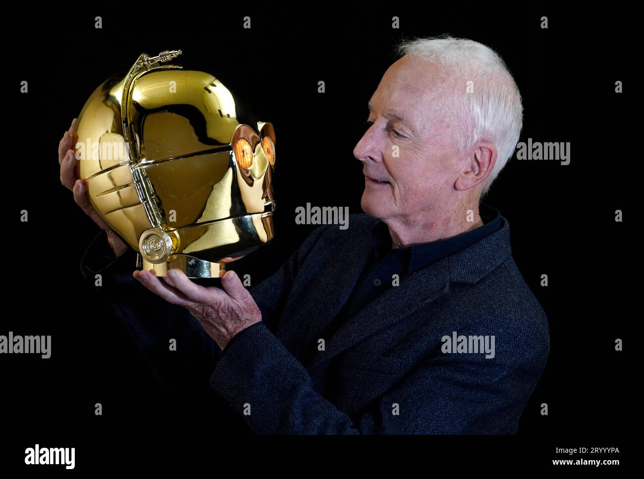 Anthony Daniels poses for a photograph with a screen matched light-up C-3PO head from the 1977 film 'Star Wars: A New Hope' (estimated £500,000 - 1,000,000) which is part of his personal collection, during a preview for the showbiz memorabilia auction, at the Propstore in Rickmansworth, Hertfordshire. Picture date: Wednesday September 20, 2023. Stock Photo