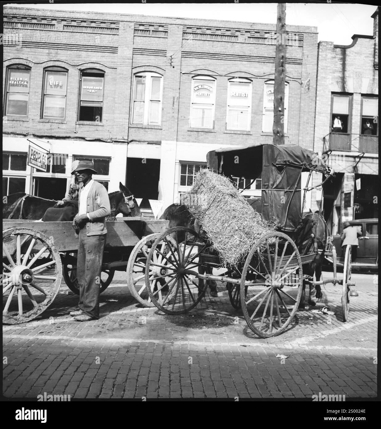 Montgomery, Alabama, USA. circa 1937.  horse-drawn carriages in front of a building. Archive Photograph in 1930s by Annemarie Schwarzenbach of depression America Stock Photo