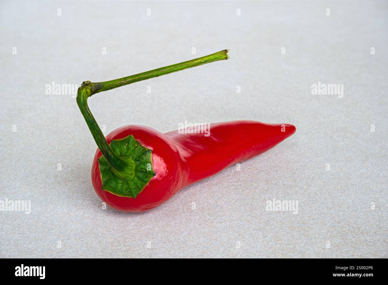Red hot pepper isolated on ceramic table top Stock Photo