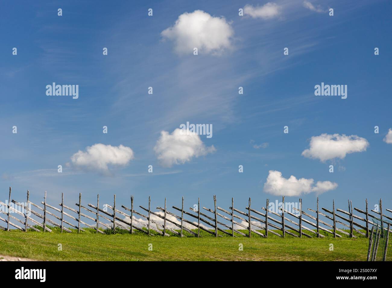Small, white clouds against a blue sky. Stock Photo