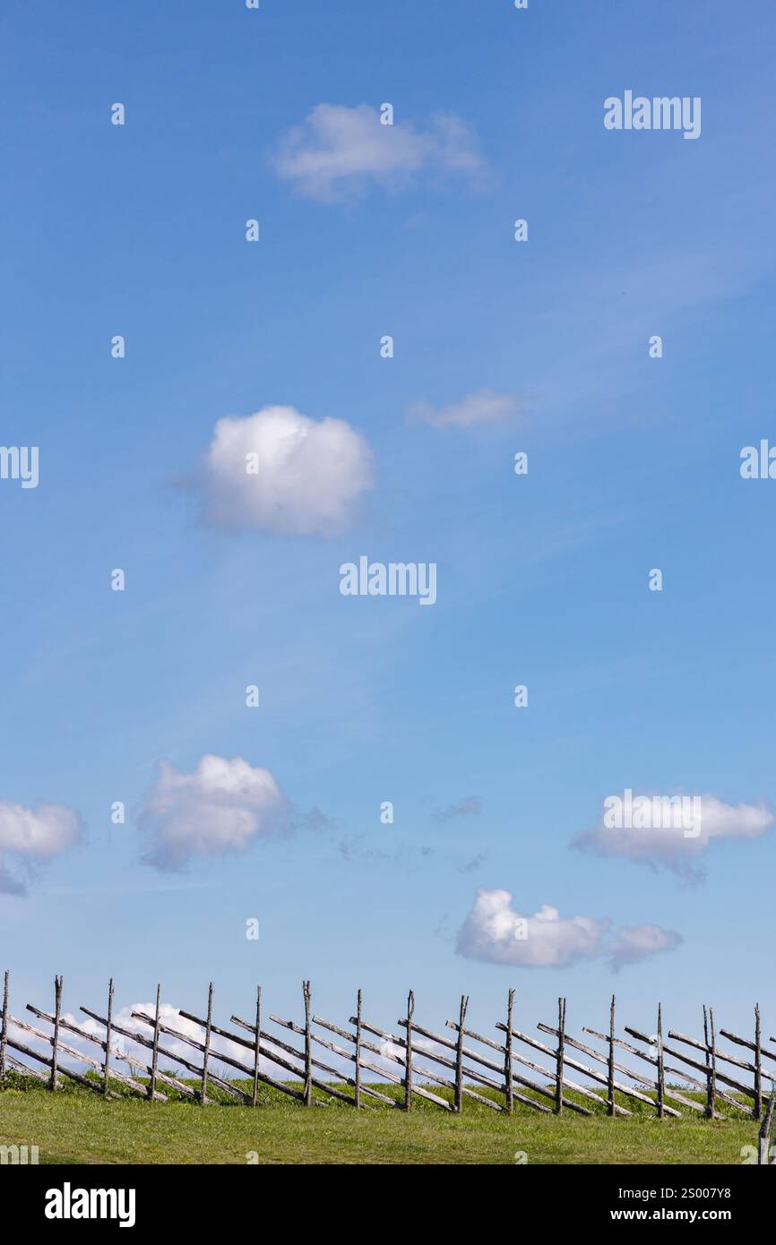 Small, white clouds against a blue sky. Stock Photo