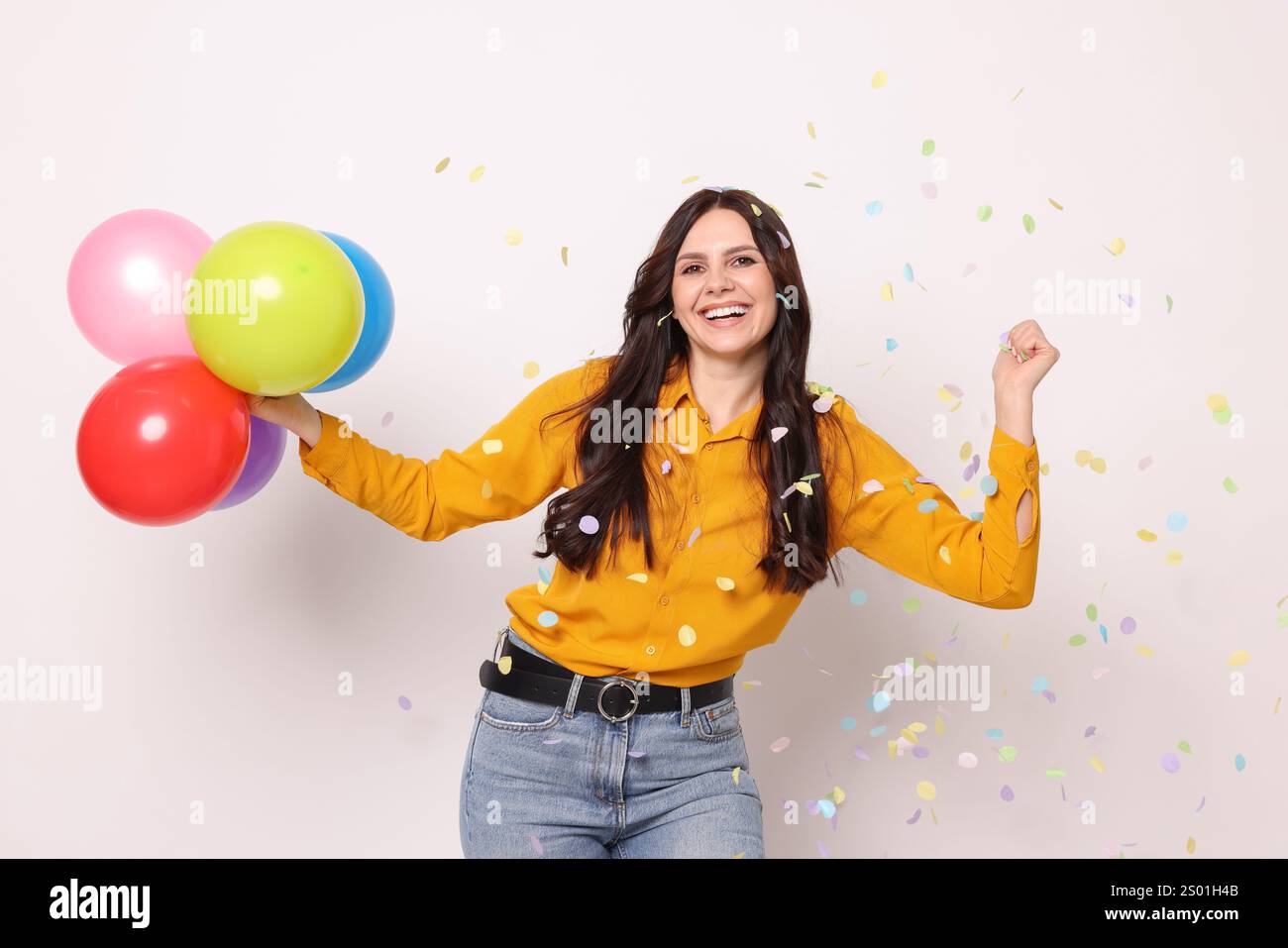 Happy Woman With Colorful Balloons Under Falling Confetti On White happy-woman-with-colorful-balloons-under-falling-confetti-on-white