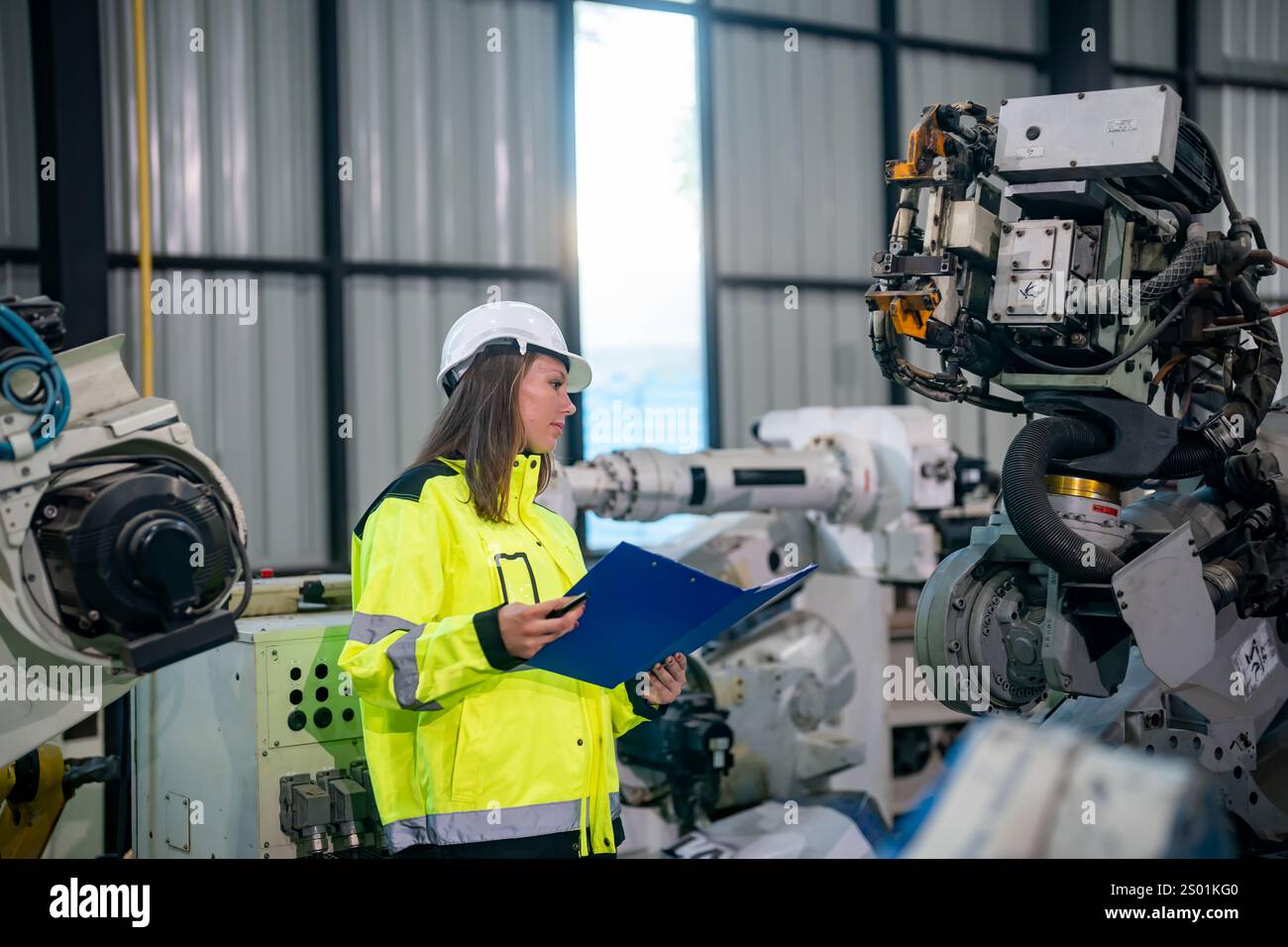 A professional wearing a safety helmet and high-visibility jacket ...