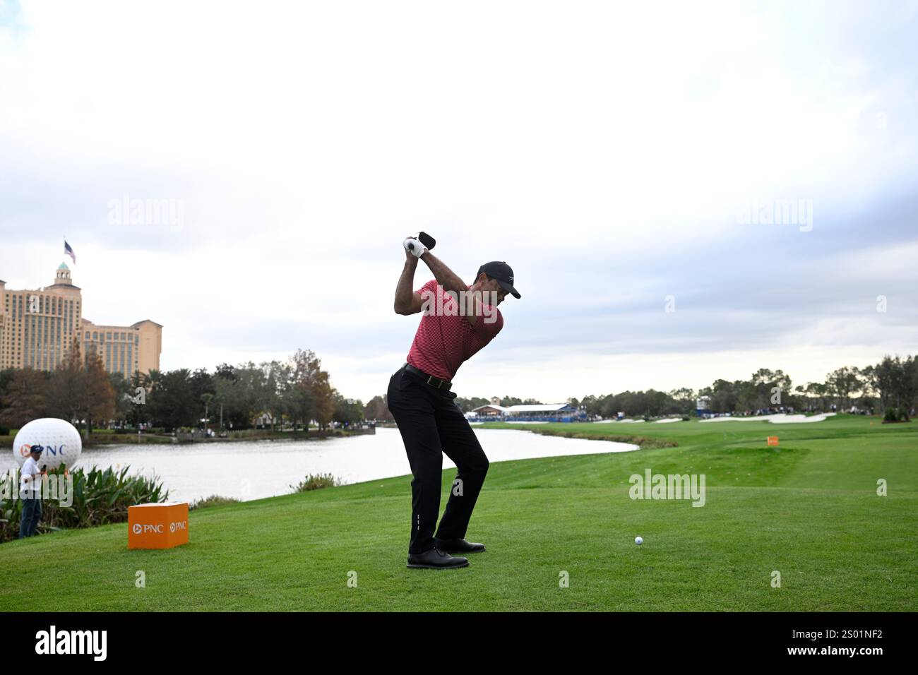 Tiger Woods tees off on the 18th hole during the final round of the PNC