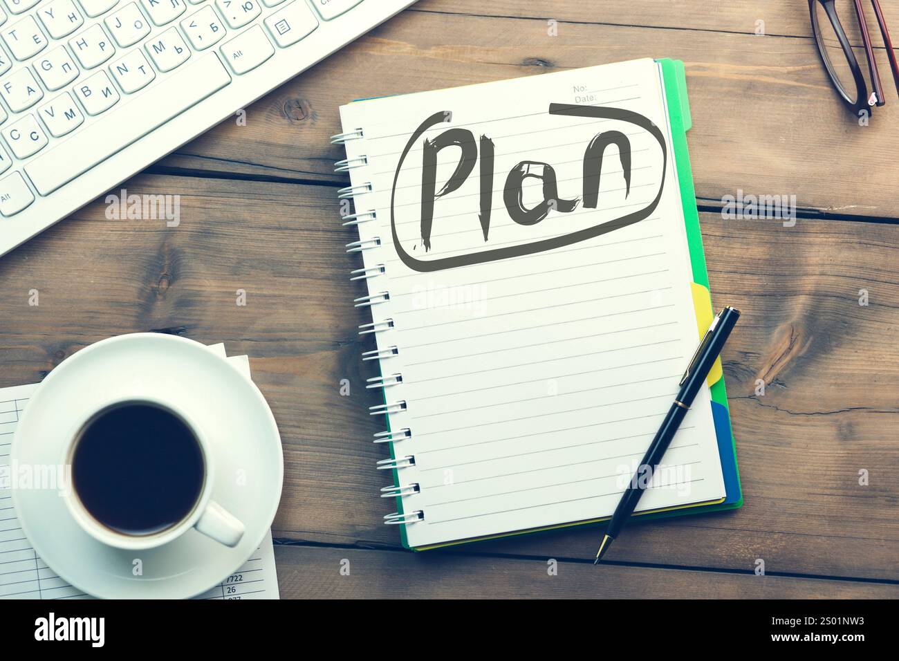 Plan text on notepad and keyboard and coffee on table Stock Photo