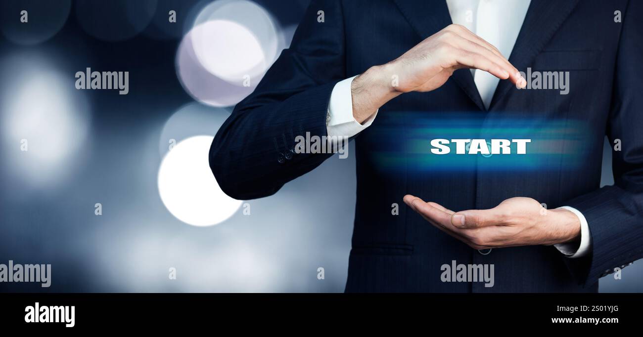 Businessman hand touching START on virtual screen Stock Photo