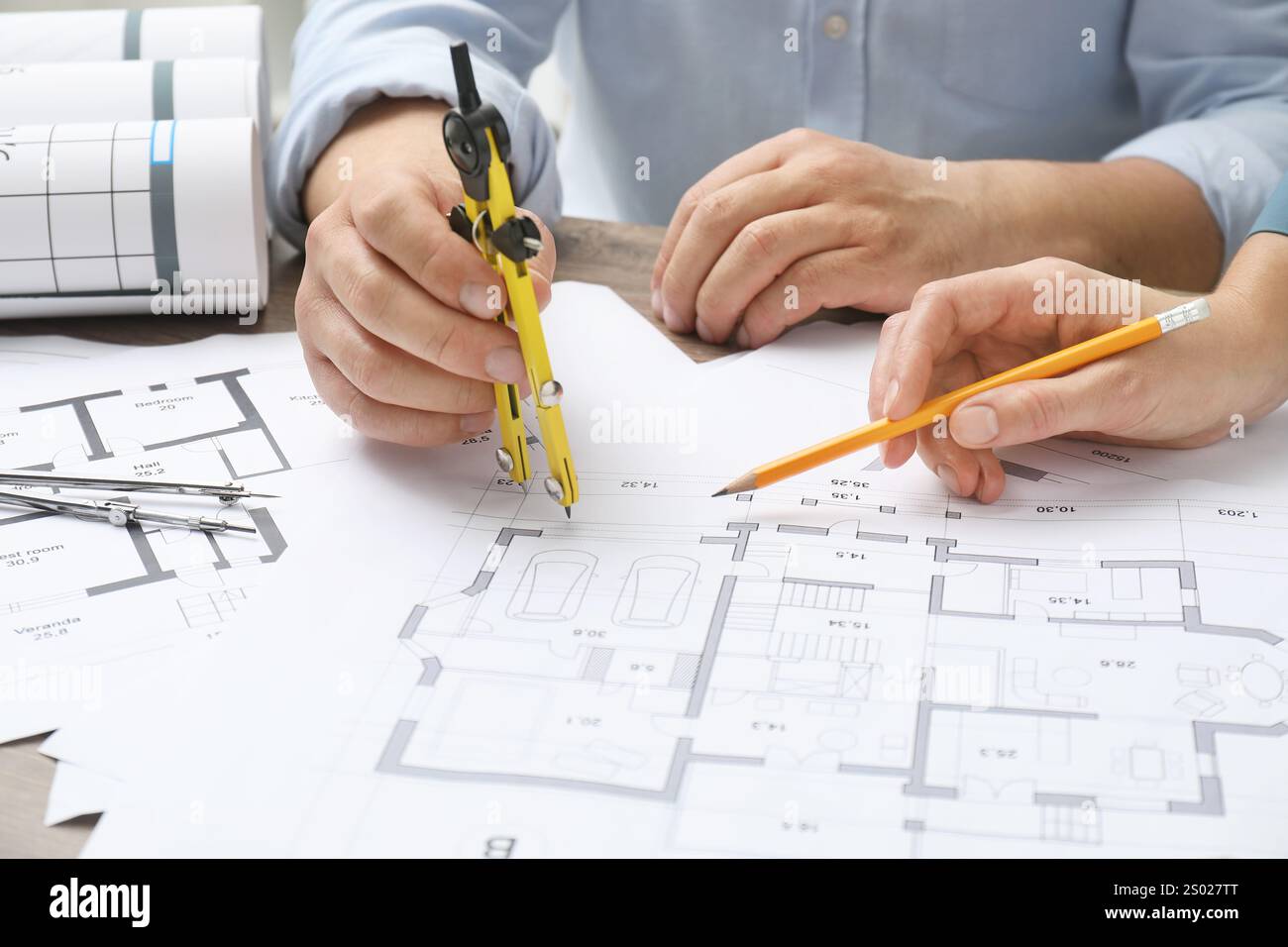 Architects working with project, closeup. Different technical drawings on wooden table Stock Photo