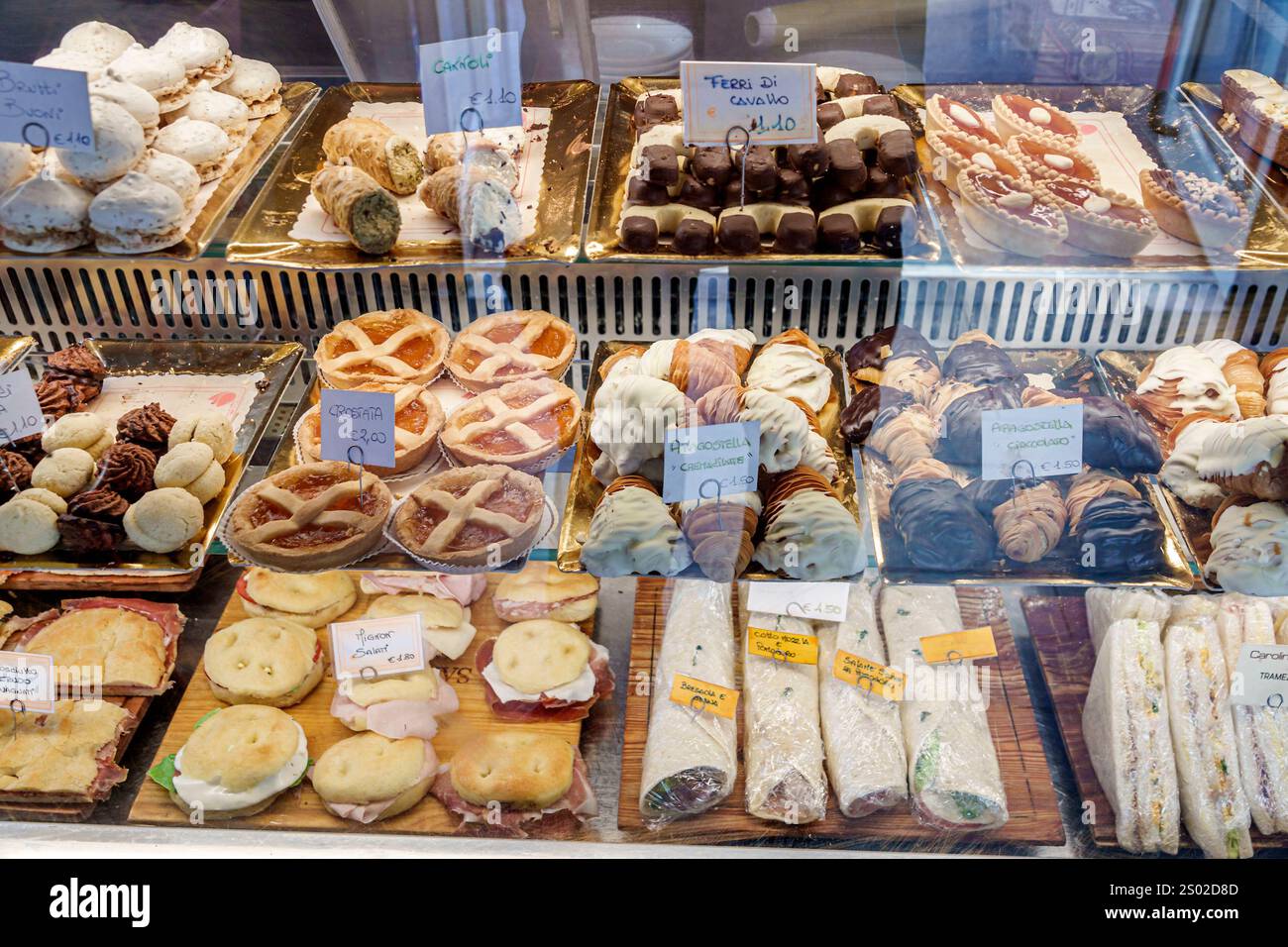 Livorno Italy,Piazza Cavour,Caffe New York Toscano,pastry display,desserts,Brutti e Buoni,Ugly but Good biscuits,Cannoli,Ferri di Cavallo,Horseshoe co Stock Photo