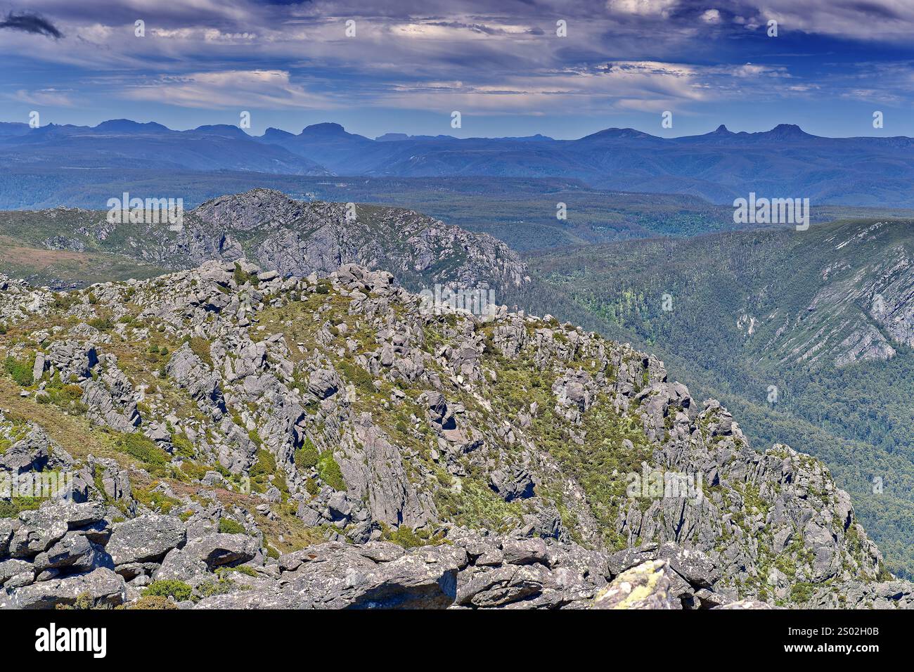 Views from the rocky summit of Mount Roland Regional Reserve peak on sunny day with blue sky, Sheffield, Tasmania, Australia Stock Photo