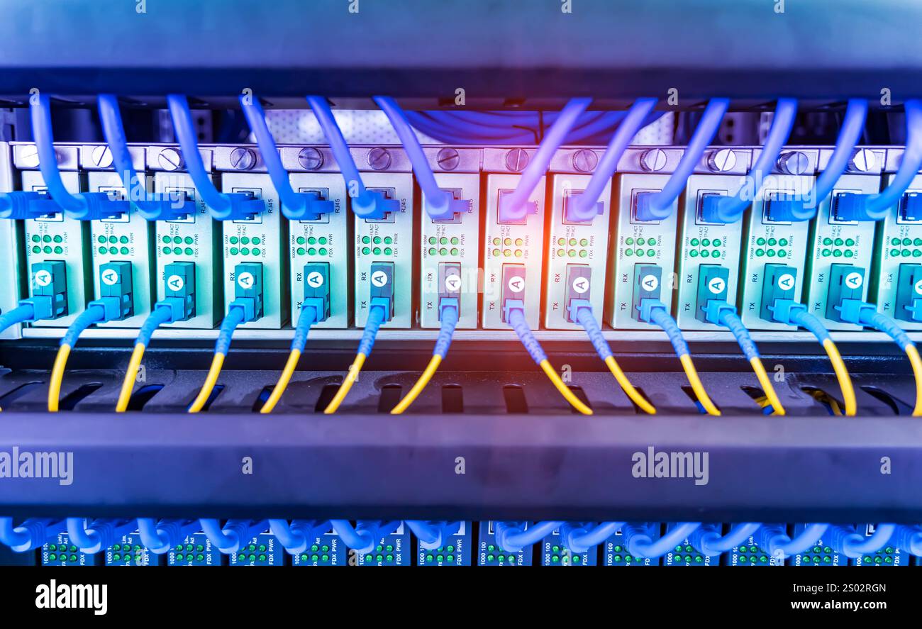 Networking Port Conduits Fiber Optic cables connected to an optic ports and Network cables ...