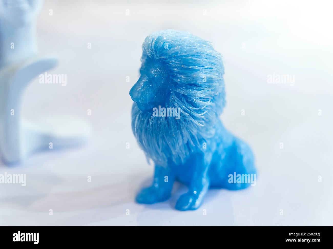 3D printer printing blue lion figure close-up. Stock Photo