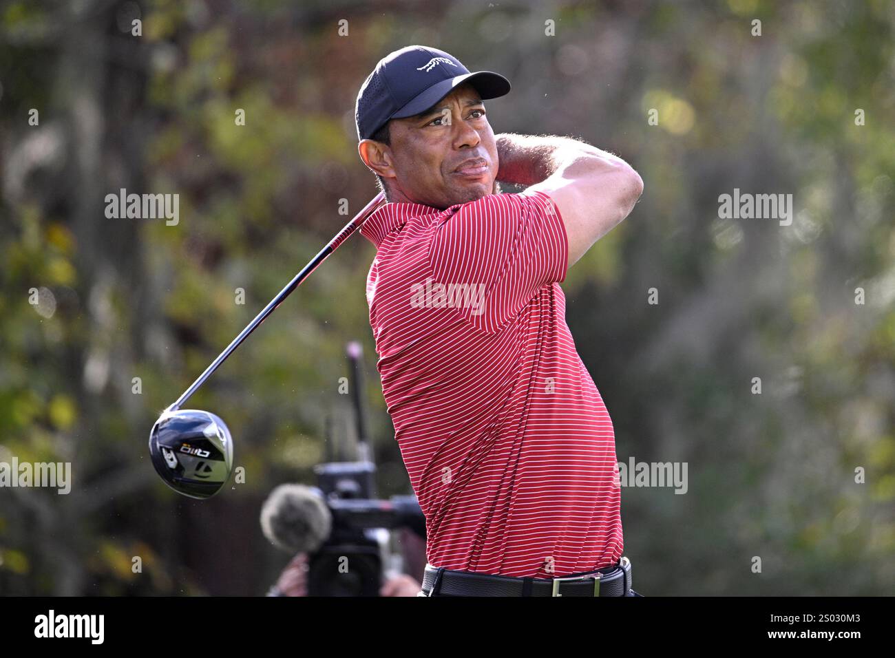 Tiger Woods tees off on the 14th hole during the final round of the PNC